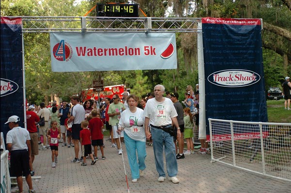 Ardis and Kevin crossing finish line